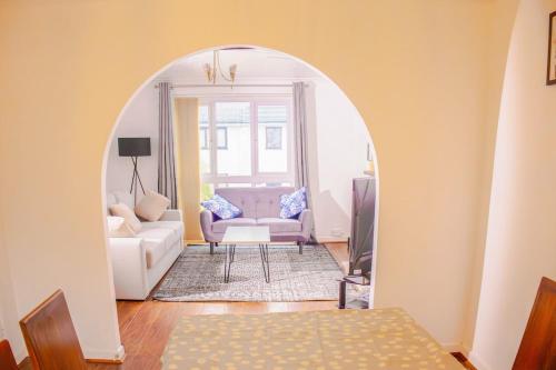 an archway leading into a living room with a couch at Spacious Newport Home Near ICC & Local Attractions in Newport