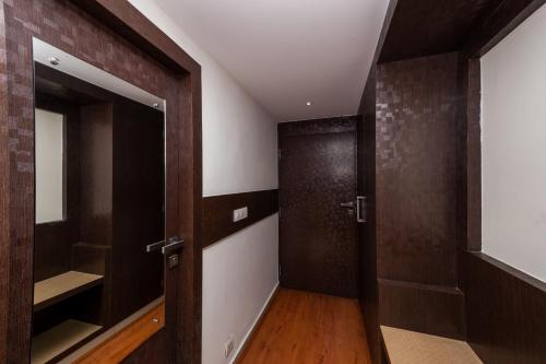 an empty hallway with a door and a staircase at The Grand Rajmahal in Bangalore