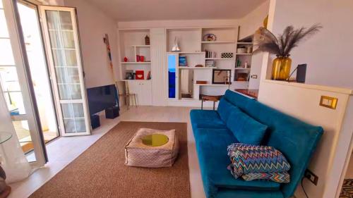 a living room with a blue couch and a table at Casa Azzurra in Pizzo
