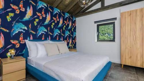 a bedroom with a bed with a mural on the wall at Villa Bohemia by Villas Guide in Dubrovnik