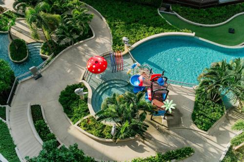 an overhead view of a swimming pool with a water park at Suite With Sea View By Mida Grande Resort in Surin Beach