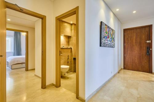 a hallway with a room with a toilet and a door at Spacious 3BR 174m2 Quiet Residential Casablanca in Casablanca