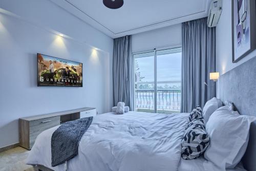 a bedroom with a bed and a large window at Spacious 3BR 174m2 Quiet Residential Casablanca in Casablanca