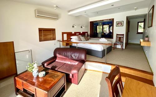 a large room with a bed and a living room at BlueWater Penthouse GuestSuite 3B in Newport