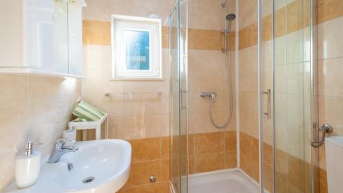 a bathroom with a sink and a shower at House Rilovic by Villas Guide in Srednji Radovčići