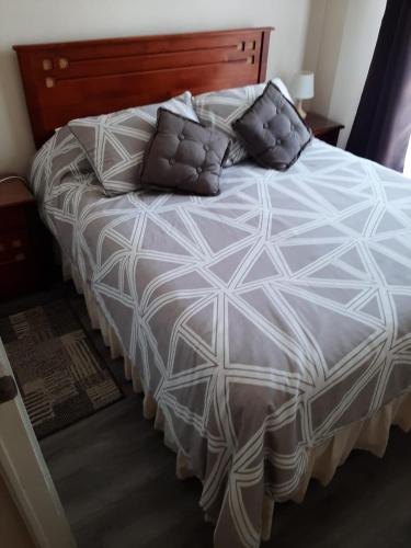 a large bed with pillows on it in a bedroom at Galicia in La Serena