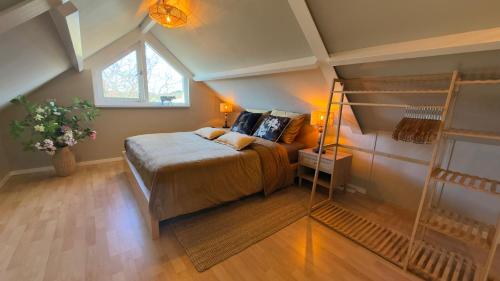 a bedroom with a bed in a attic at Tulipa Near Beach & Dunes with Free Parking in Noordwijkerhout