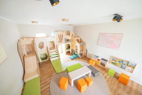 a room with a play area with wooden play structures at Haus Lindolino in Elsterheide