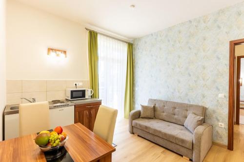 a living room with a couch and a table at B&B Lajta Park in Mosonmagyaróvár