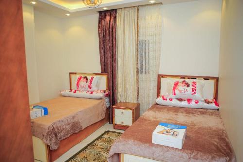 a small room with two beds and a window at المحافظة in Kafr al Ishārah