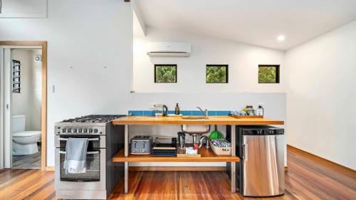 a kitchen with a sink and a stove at Beautiful high-set studio close to beach in Ocean Shores