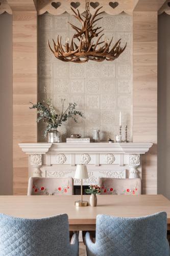 a dining room with a table and a chandelier at Willa Jędruś in Murzasichle