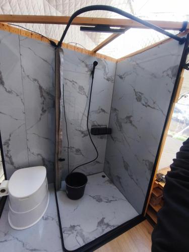 a bathroom with a toilet in a tent at Wild Glamping Liptov in Liptovský Ondrej