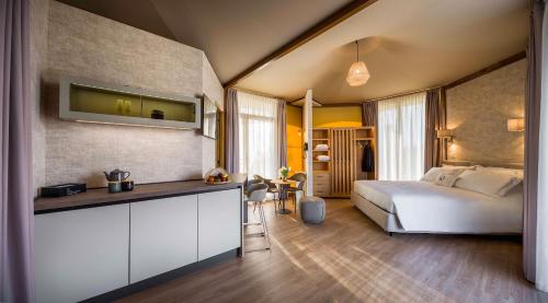a bedroom with a bed and a desk with a tv at Tresort Oil Glamping in Principina Terra