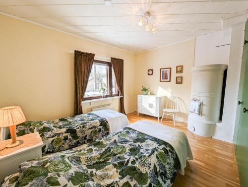 a bedroom with two beds and a window at A little home in Lahti