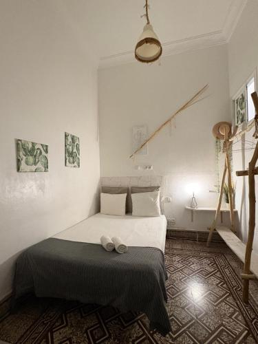 a bedroom with a bed with two shoes on it at Cactus Host in Las Palmas de Gran Canaria