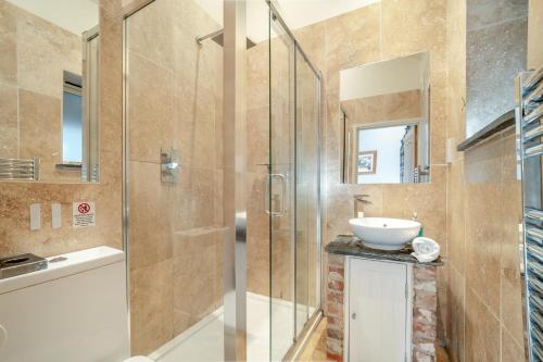a bathroom with a glass shower and a sink at 2 Bed in Farnham oc-t34459 in Farnham