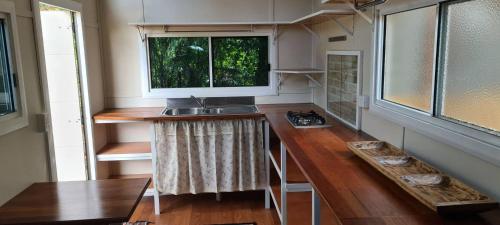 a kitchen in a tiny house with a sink at Forest Gypsy Tiny Home in Barkers Vale