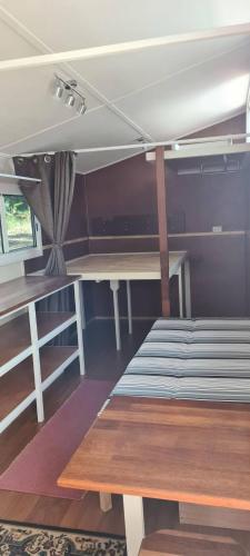 a room with two bunk beds and a table at Forest Gypsy Tiny Home in Barkers Vale