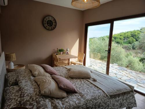 a bedroom with a bed with pillows and a large window at La única in Coín