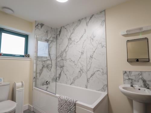 a bathroom with a shower and a sink at Sonas in Strathcarron