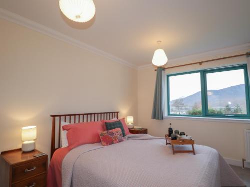 a bedroom with a bed and a large window at Sonas in Strathcarron