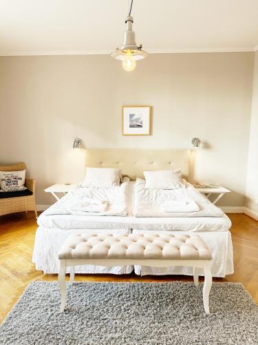 a bedroom with a large white bed with a rug at Wisby Residence in Visby