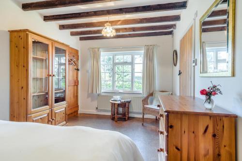 a bedroom with a bed and a desk and windows at 3 Bed in Awre oc-s34503 in Awre