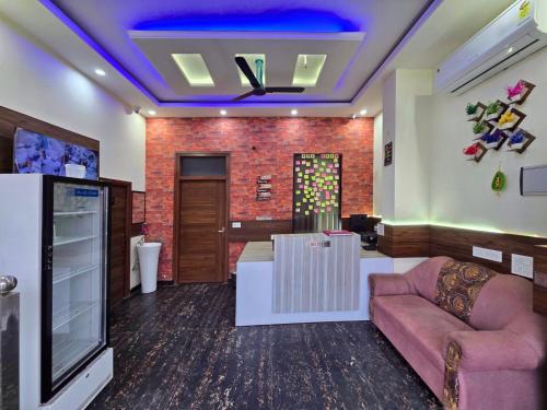 een woonkamer met een bank en een tv bij Hotel The SOHO in Chandīgarh