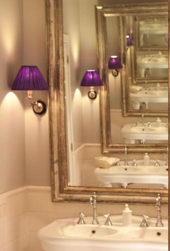 a bathroom with two sinks and a mirror at Cellai Hotel Florence in Florence