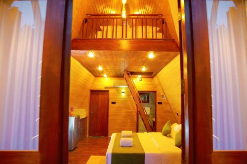 a small room with a bed and a staircase at Villa Anaa in Habaraduwa Central
