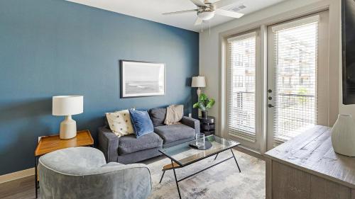 a living room with a couch and a table at Landing Apartments - The Quinn in Anna