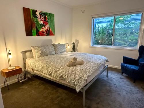 a bedroom with a bed with a hat on it at Spacious 4bdr family home away from home in Newport