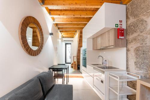 a kitchen and living room with a couch and a table at GuestReady - charming retreat in Porto in Porto
