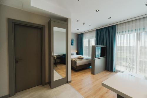 a room with a door leading to a bedroom at Stillo Business Hotel & Spa in Aliağa
