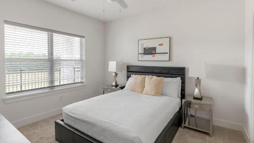 een witte slaapkamer met een bed en twee nachtkastjes bij Landing Beautiful 3BD Yoga Studio Pool in Athens