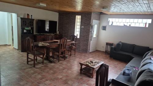 a living room with a couch and a table and chairs at Complejo Casablanca Plottier in Plottier