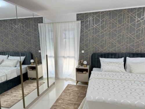 a bedroom with two beds and a mirror at Apartmani Beril Lux in Rovinj