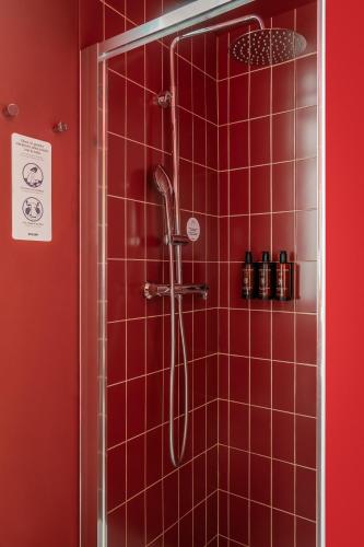 a red tiled shower in a red bathroom at BYPILLOW The Citadel in Madrid