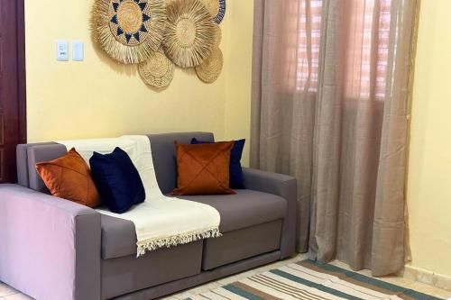 a couch with pillows on it in a living room at Maré · Casa Maré in Aracati