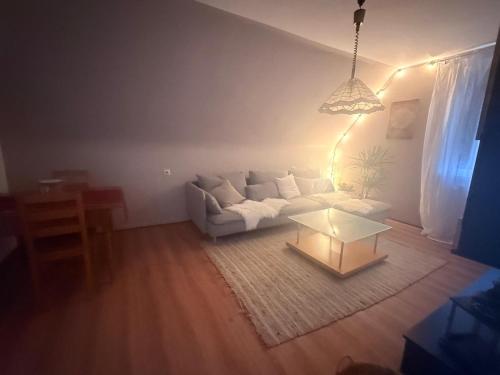 a living room with a white couch and a table at SeeNah in Niederdorla