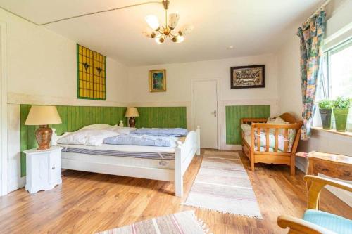 a bedroom with a bed and a chair in it at KAL1031-Boda-Glasbruk-Storgatan-32 in Boda Glasbruk