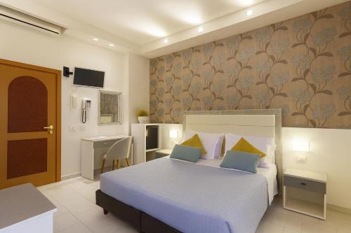 a hotel room with a bed and a desk at ELISABETTA hotel in Cesenatico