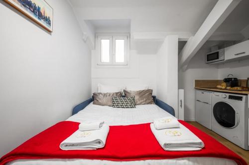 une chambre avec un lit avec une couverture rouge dans l'établissement Le Coq Chiron - AC - Wi-Fi - Monaco border, à Monte-Carlo