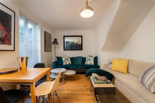 a living room with a couch and a table at 3 Bedroom 2 Bath Serviced Apartment, Hackney & Shoreditch, Sleeps 8 in London