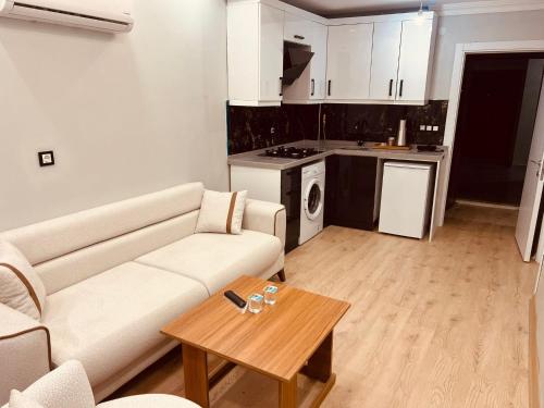 a living room with a couch and a table at Bediroğlu apart in Arnavutköy