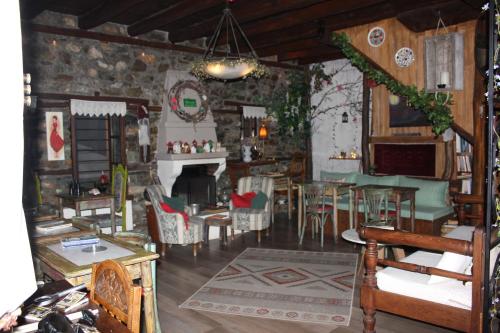 a living room with a table and chairs at Feggaropetra Inn Magic Mountain House in Palaios Panteleimon