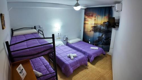 Ce dortoir comprend 3 lits superposés et des draps violets. dans l'établissement Apartalux Supreme Suite, à Carboneras