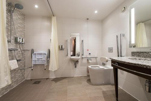 a bathroom with a toilet and a sink and a shower at Hampton By Hilton Edinburgh West End in Edinburgh
