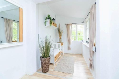 a hallway of a home with white walls and a mirror at KAL911-Hjorted-Sandekulla in Gissebo